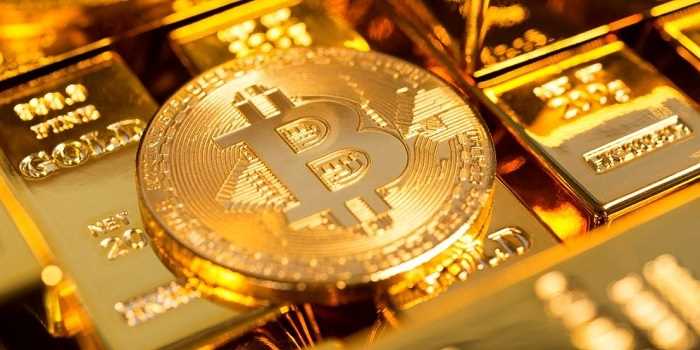 bitcoin gold coin sitting on top of gold bars