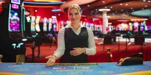 Live dealer sits at table